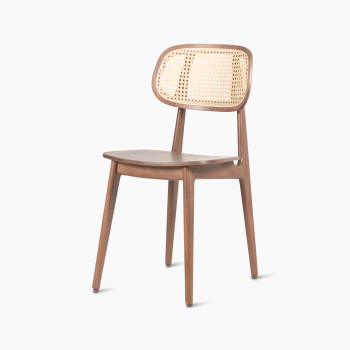 45 degree view of a Titus dining chair in tobacco stained beech with a woven cane backrest and a solid plywood seat.