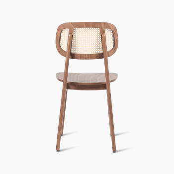 Titus dining chair in tobacco-stained beech wood with a cane backrest and plywood seat, shown from the rear view.