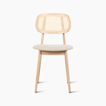 Titus dining chair in natural varnished oak with a rattan backrest and lime white bouclé upholstered seat, front view.