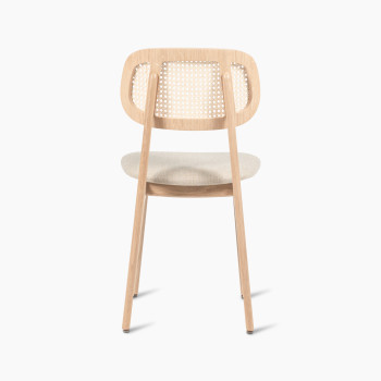 Titus dining chair in natural varnished oak with a rattan backrest and lime white bouclé upholstered seat, rear view.