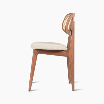 Titus dining chair in tobacco-stained beech with a rattan backrest and lime white bouclé upholstered seat, side profile view.