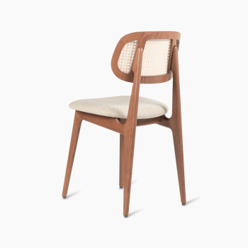 Titus dining chair in tobacco-stained beech with a rattan backrest and lime white bouclé upholstered seat, rear three-quarter view.