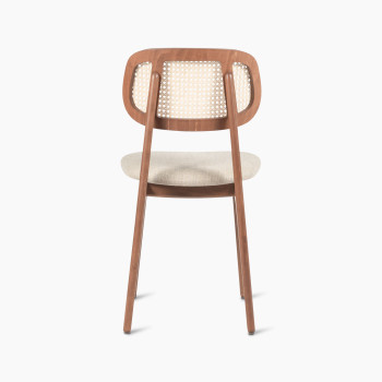 Titus dining chair in tobacco-stained beech with a rattan backrest and lime white bouclé upholstered seat, rear view.