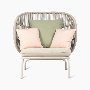 Kodo Cocoon by Vincent Sheppard with almond seat, and decorative cushions in olive green and blush, front view.