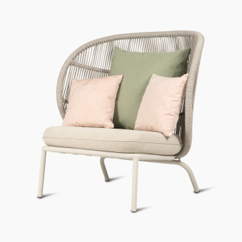 45-degree view of Kodo Cocoon by Vincent Sheppard with almond seat and decorative cushions in olive green and blush.