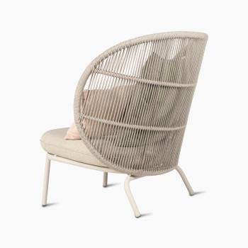 Rear 135-degree view of Kodo Cocoon by Vincent Sheppard with almond seat and decorative cushions in olive green and blush.