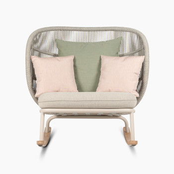 Kodo rocking chair in Dune white with almond seat, and decorative cushions in olive green and blush by Vincent Sheppard, front view.