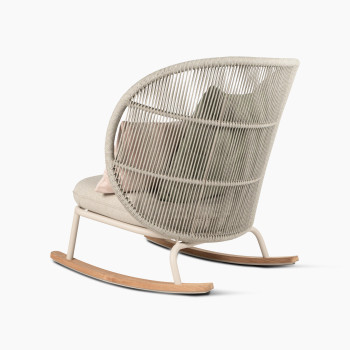 Rear 135-degree view of the Kodo rocking chair in Dune white with almond seat and decorative cushions in blush and olive green by Vincent Sheppard.