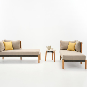 Two Vincent Sheppard Lento chaise longues in teak with stone dust cushions, accompanied by a Lento side table in untreated teak and Portland finish, decorated with a ceramic jug and cup.