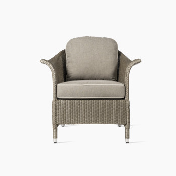 Front view of Vincent Sheppard Victor lounge chair with Lloyd Loom weave and beige cushions, designed for indoor spaces.