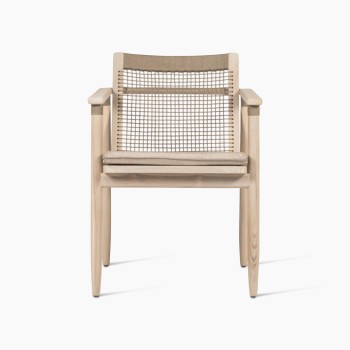 Front view of the David dining armchair by Vincent Sheppard, an outdoor dining chair with a natural wooden frame, woven backrest, and cushioned seat