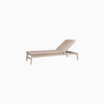 David sunlounger by Vincent Sheppard, viewed at a 45-degree angle, with the backrest lifted to a 60-degree angle and featuring a natural wooden frame with a beige cushion for comfort.