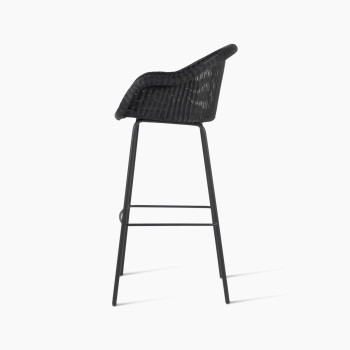 Side view of the Edgard barstool by Vincent Sheppard, featuring a black wicker seat and steel base.