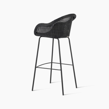 Edgard barstool by Vincent Sheppard, viewed from the back at a 135-degree angle, featuring a black wicker seat and steel base.