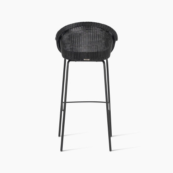 Back view of the Edgard barstool by Vincent Sheppard, featuring a black wicker seat and a steel base.