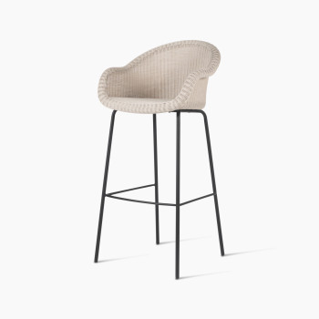 Edgard barstool by Vincent Sheppard, featuring an old lace-coloured wicker seat and a black steel base, viewed at a 45-degree angle.