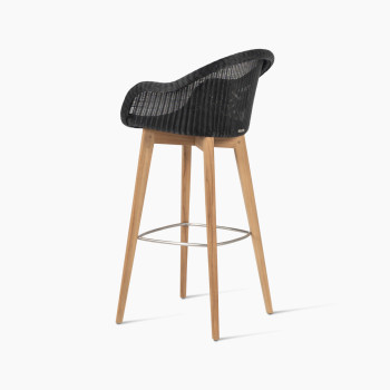 Edgard barstool with an untreated teak base and black wicker seat by Vincent Sheppard, 135-degree angle view.