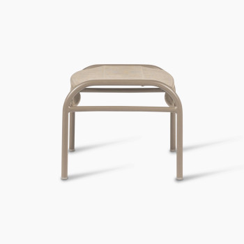 Side view of the Loop footrest in taupe by Vincent Sheppard, showcasing its curved metal frame and finely woven Lloyd Loom surface, ideal for relaxing your feet.