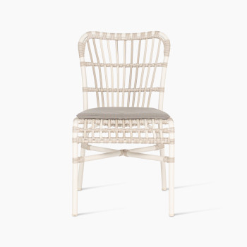 Lucy dining chair by Vincent Sheppard, made of synthetic wicker in off-white colour, featuring a woven design and a grey cushion