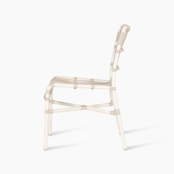 Side profile of the Lucy dining chair by Vincent Sheppard, made of synthetic wicker in off-white colour with a woven design and no cushion.