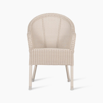 Mia dining chair in old lace colour, shown from the front view. The chair features a wicker frame with a rounded backrest and clean, simple lines. 