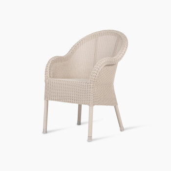 Mia dining chair in old lace colour, shown from the front view. The chair features a wicker frame with a rounded backrest and clean, simple lines