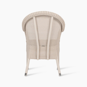 Mia dining chair in old lace colour, shown from the back view. The chair features a wicker frame with a rounded backrest and vertical supports, highlighting its structured yet elegant design.