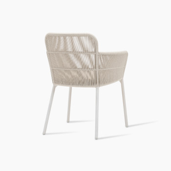 Rear 135-degree view of Vincent Sheppard’s Akari dining chair, showcasing its aluminium frame and rope-woven back in dune white, with a Santal-coloured seat cushion.