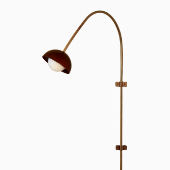 Arvin swivel wall lamp from Vincent Sheppard, featuring a handmade ceramic shade in maroon and a brass swivel tube for a refined, elegant look.