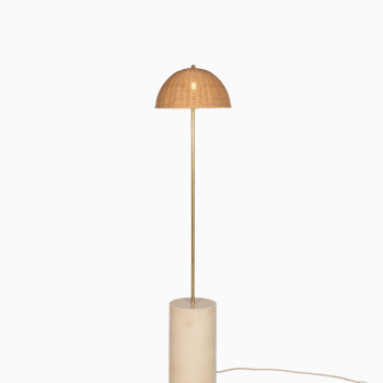 Packshot of the Arvin floor lamp featuring a cylindrical ceramic base in mushroom colour, a slender brass stem, and a woven rattan dome-shaped shade.